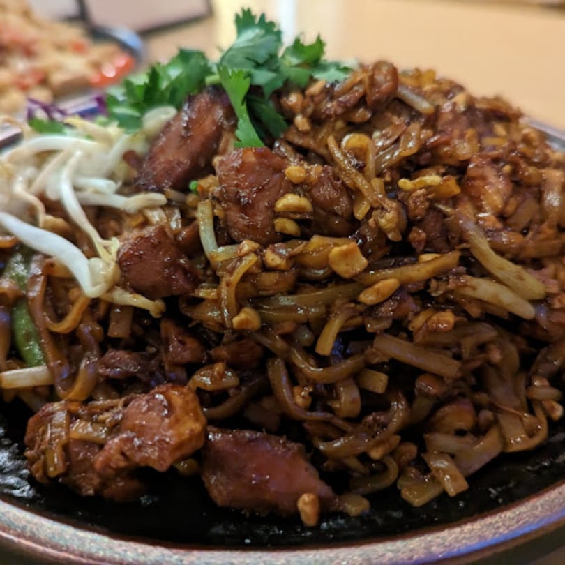 Close-up of Penny's Thai Pad See Ew with chicken, wide noodles, and bean sprouts.